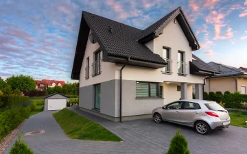 House with car parked in driveway.