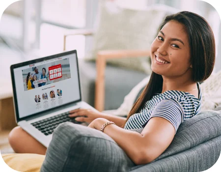 Woman with a laptop looking for homeowners insurance