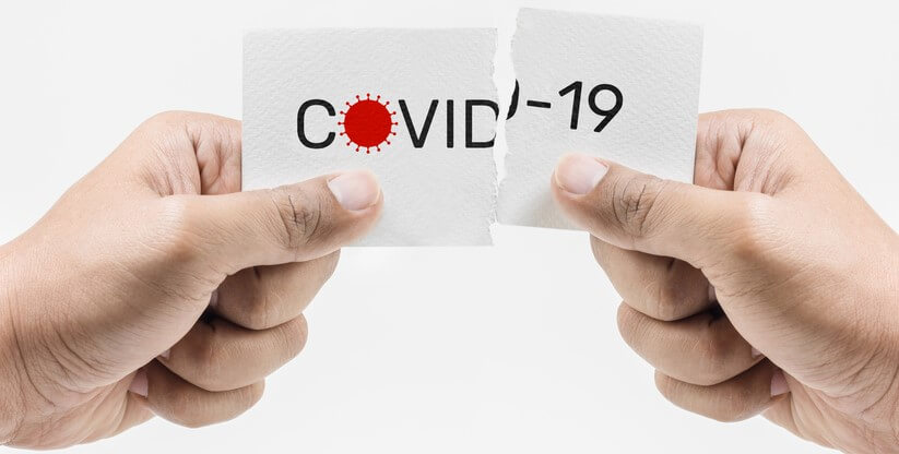 business_liability_insurance_coronavirus hands holding a ripped paper that says covid-19