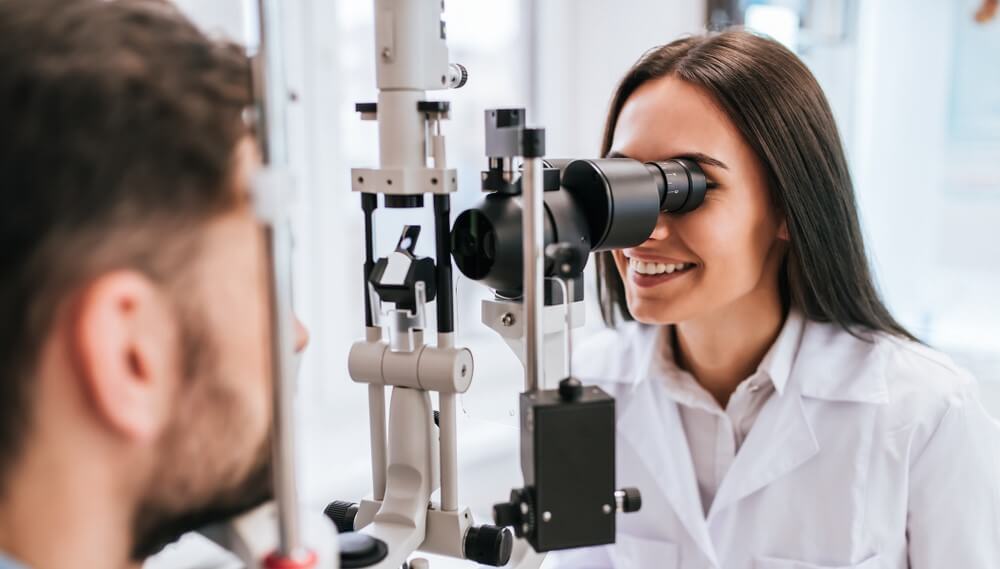 woman eye doctor checking a patient with vision insurance