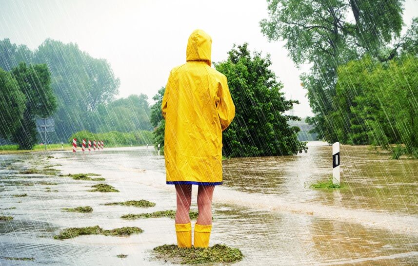 girl with yellow raincoat watching a flood in the rain do i need flood insurance