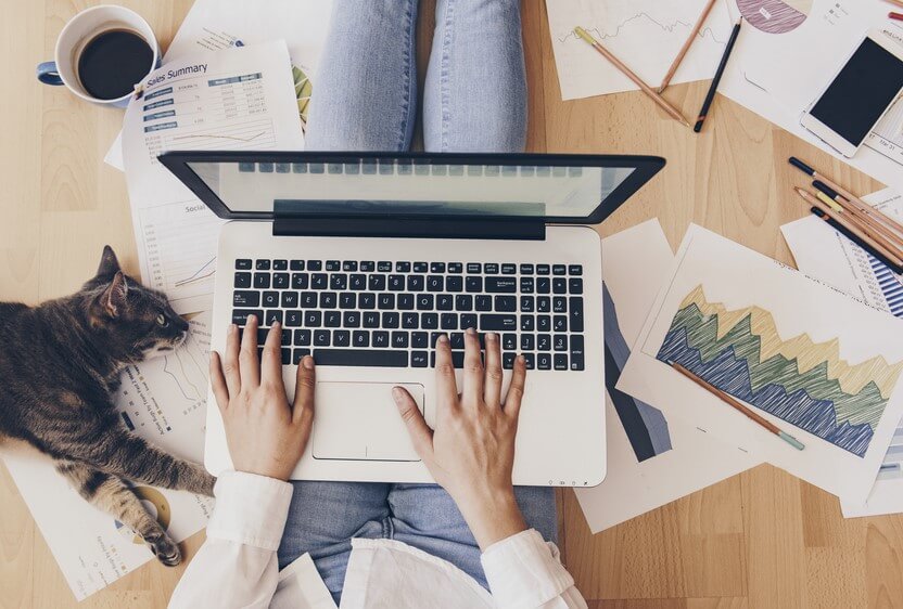 woman working from home on her floor with  a car due to coronavirus