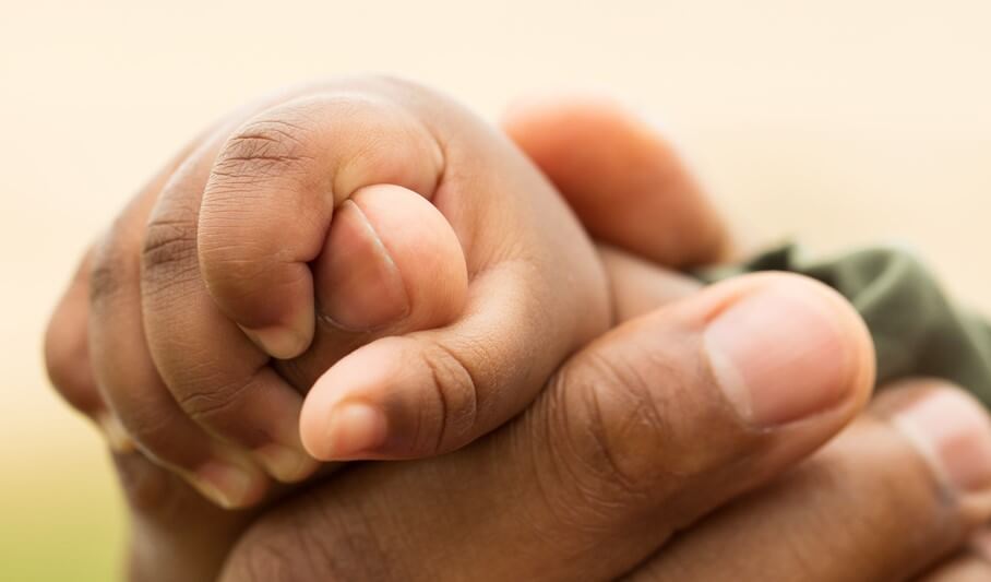 baby hand holding an adult hand newborn insurance