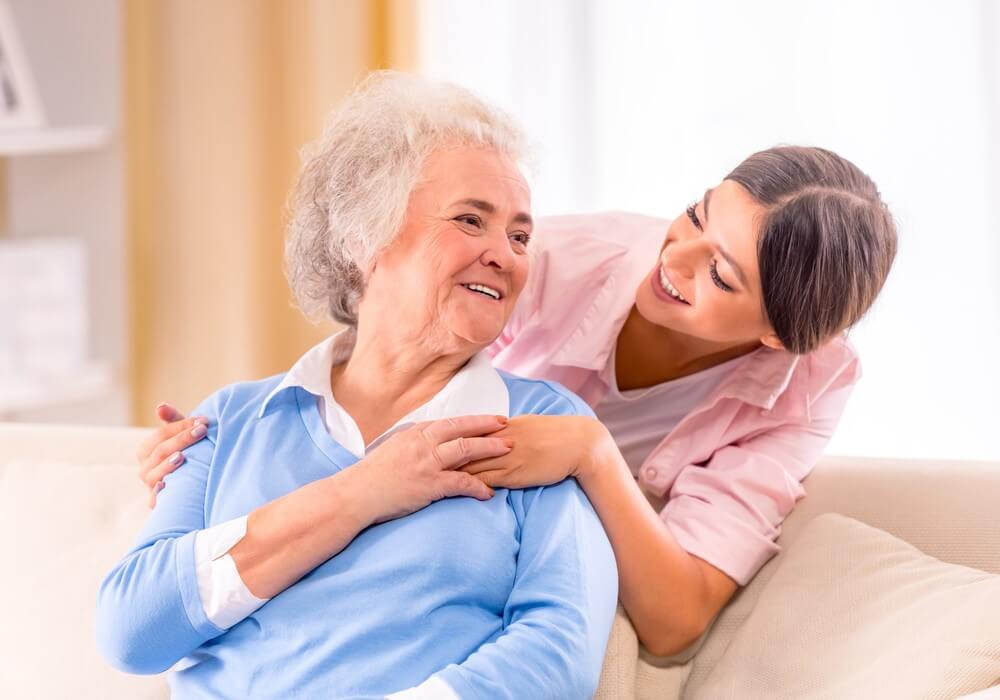 nurse talking to senior woman at in home care