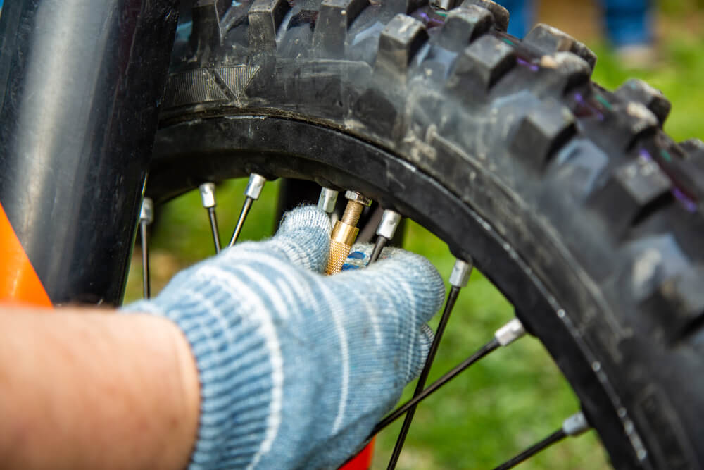 hand checking motorcycle tire preassure motorcycle maintance