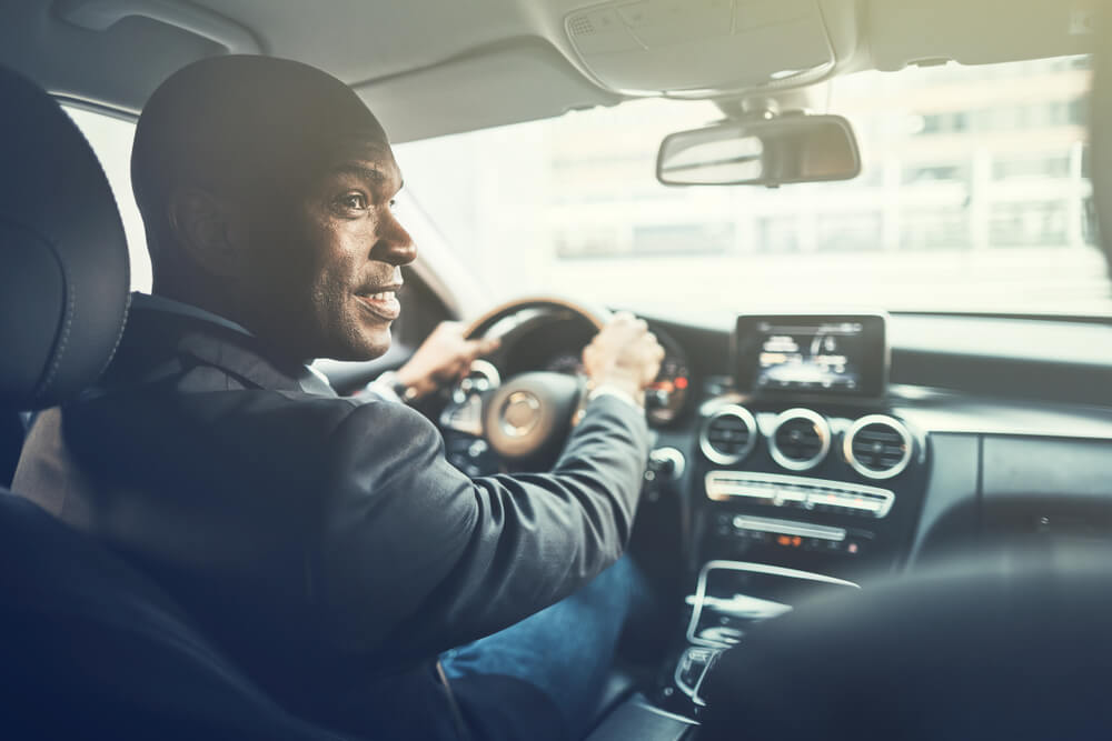 african american man driving an automatic transmission car