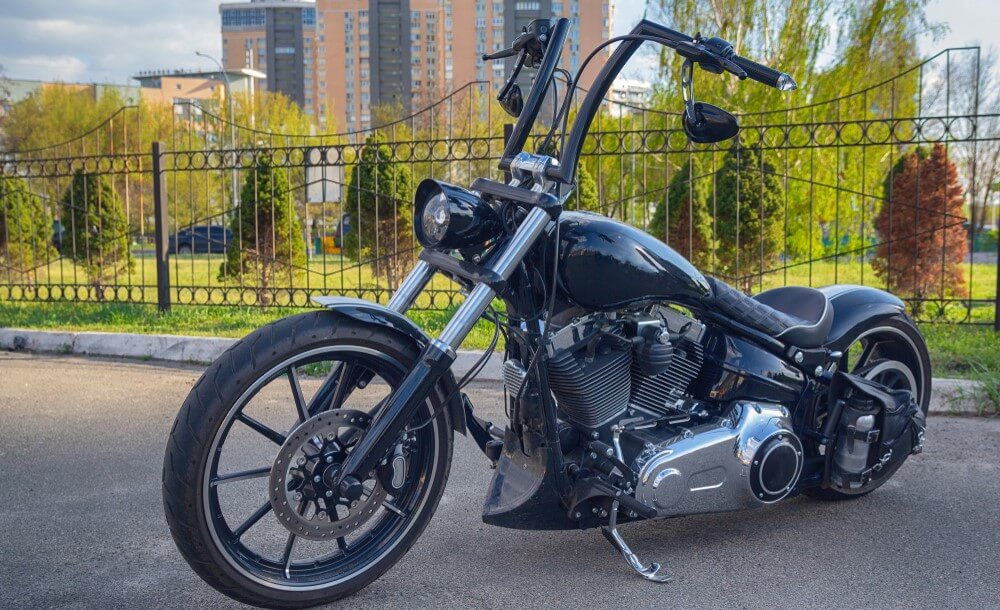 custom chopper motorcycle parked on a street with insurance