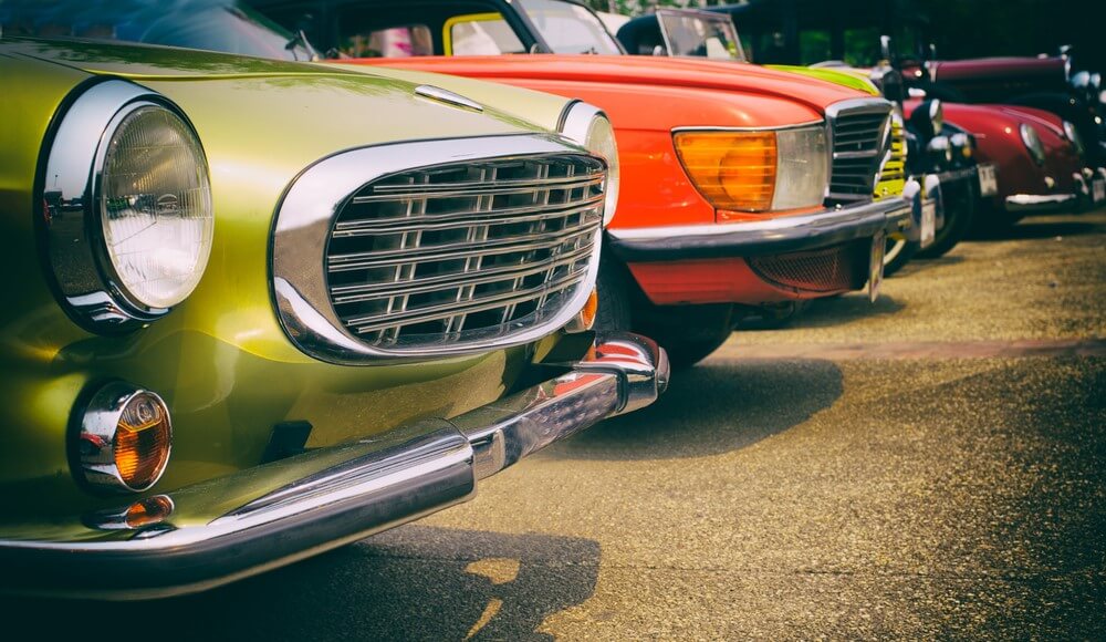 row of classic and antique cars parked