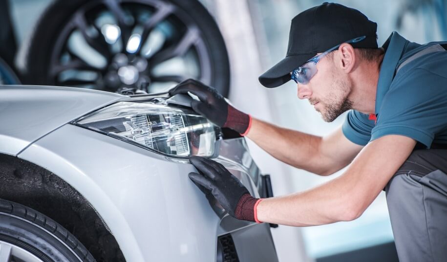 mechanic checking led headlights in car