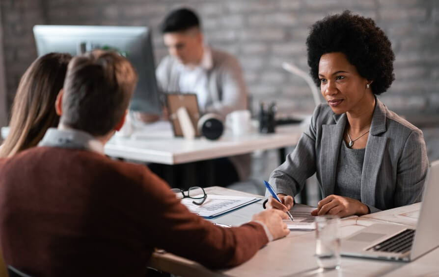 agent talking to couple in office about what is coinsurance