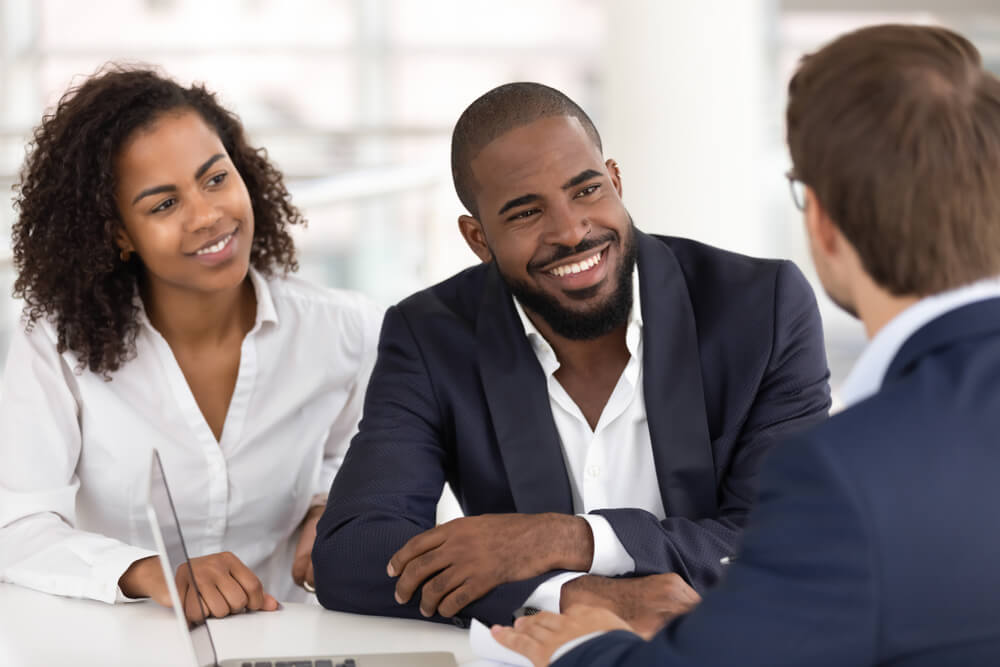african american couple taking to an agent about life insurance