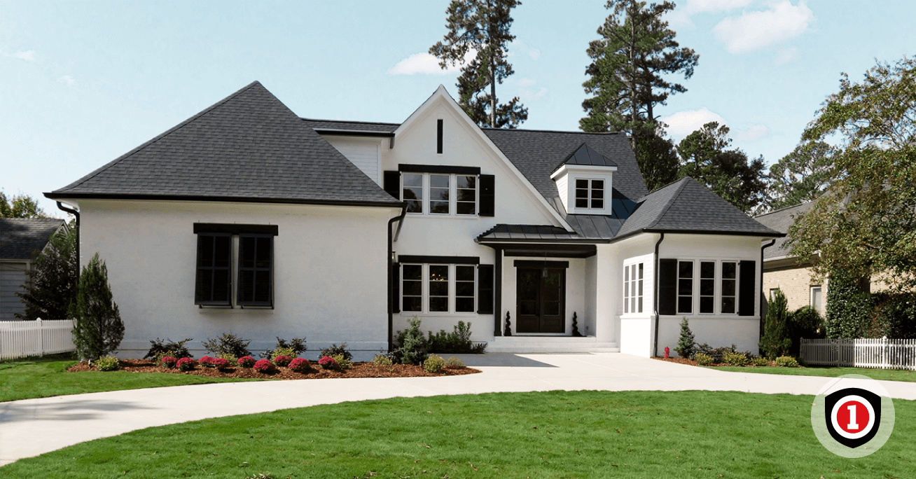 A white house with a green yard