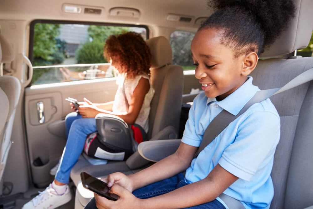 Children Using Digital Devices On Car seats safely