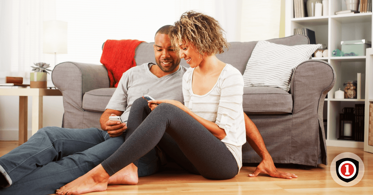 happy couple sitting in their rented apartment 