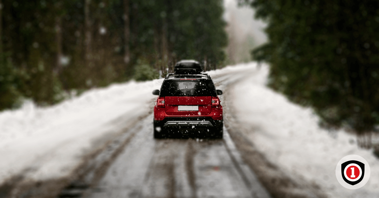 Red car driving in a winter weather