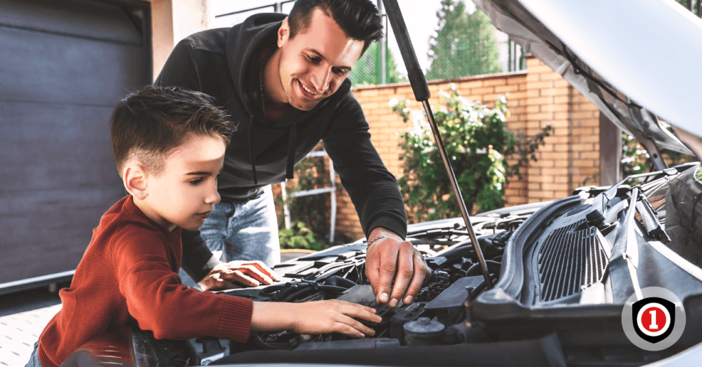 Father and son reviewing  the motor of their auto