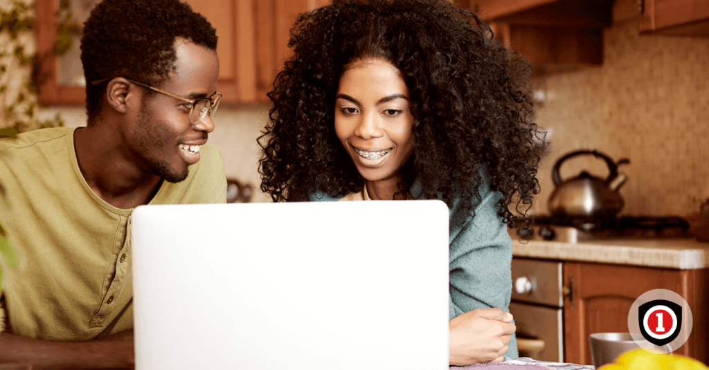 Couple searching life insurance options on a computer