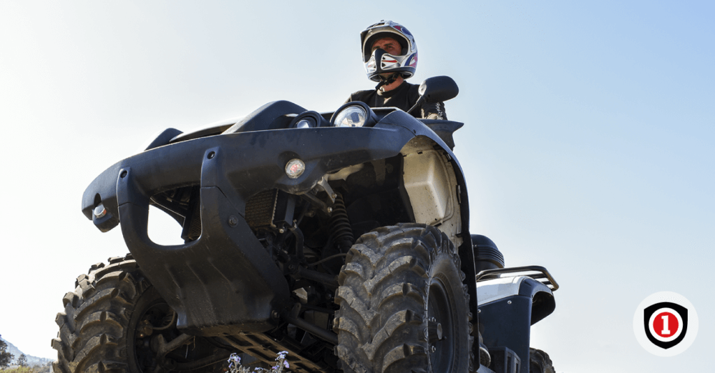 A man riding a quad bike while he has an ATV coverage