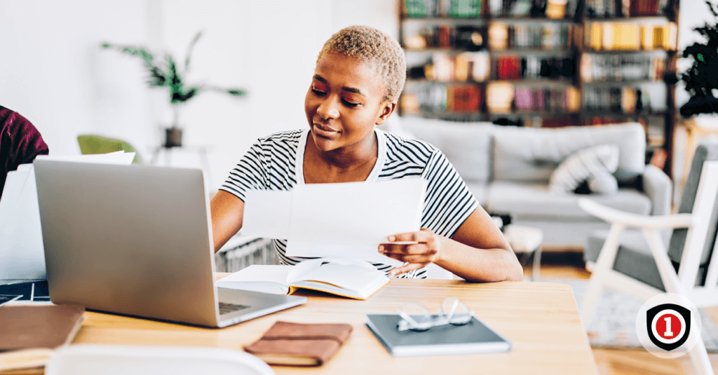 An african america women calculating how much renters insurance coverage needs while she use her computer