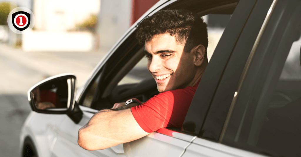 A Teen driver smiling while driving