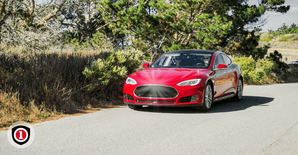 A red auto with car insurance coverage on the road