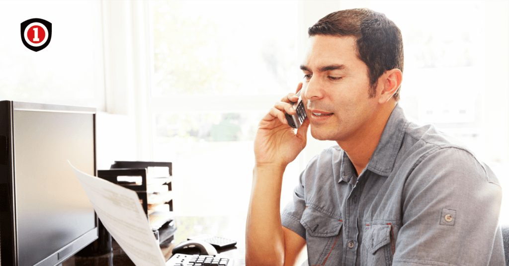  A man talking on the phone while reviewing an insurance policy