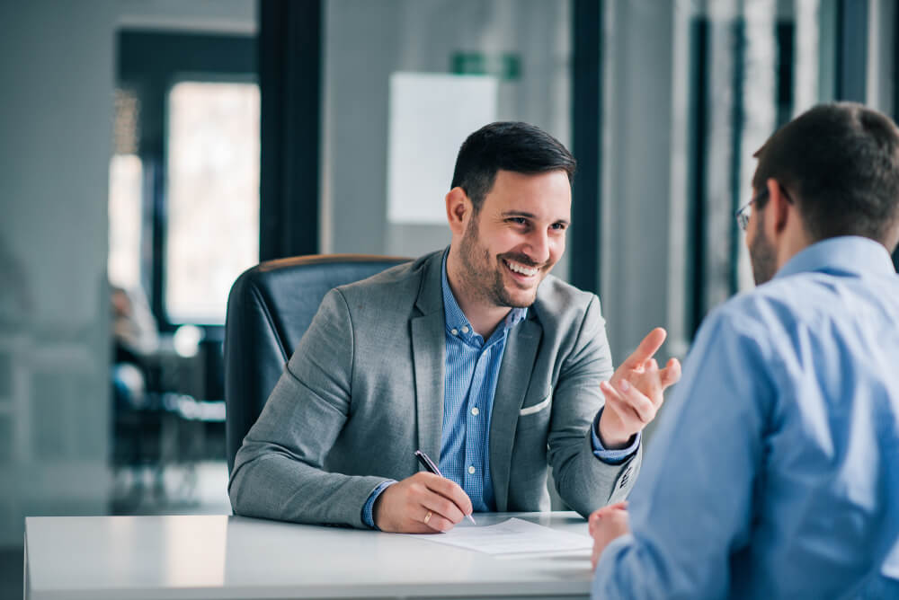 benefits package Man having a business meeting and signing a contract, recruitment or agreement