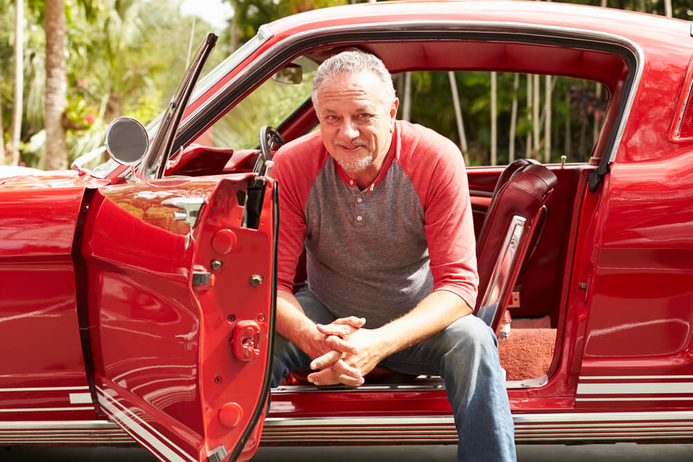 male senior man sitting in his classic car