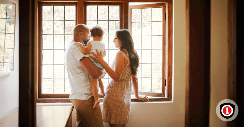 Young family watching through the window while enjoying homeowner insurance