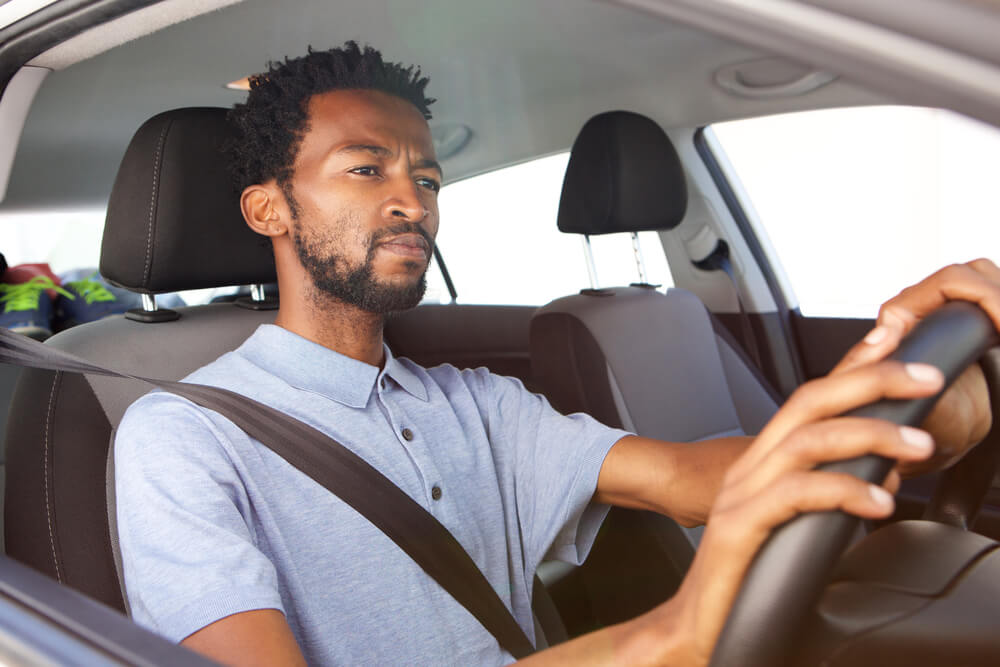 Close up portrait of african american man driving car