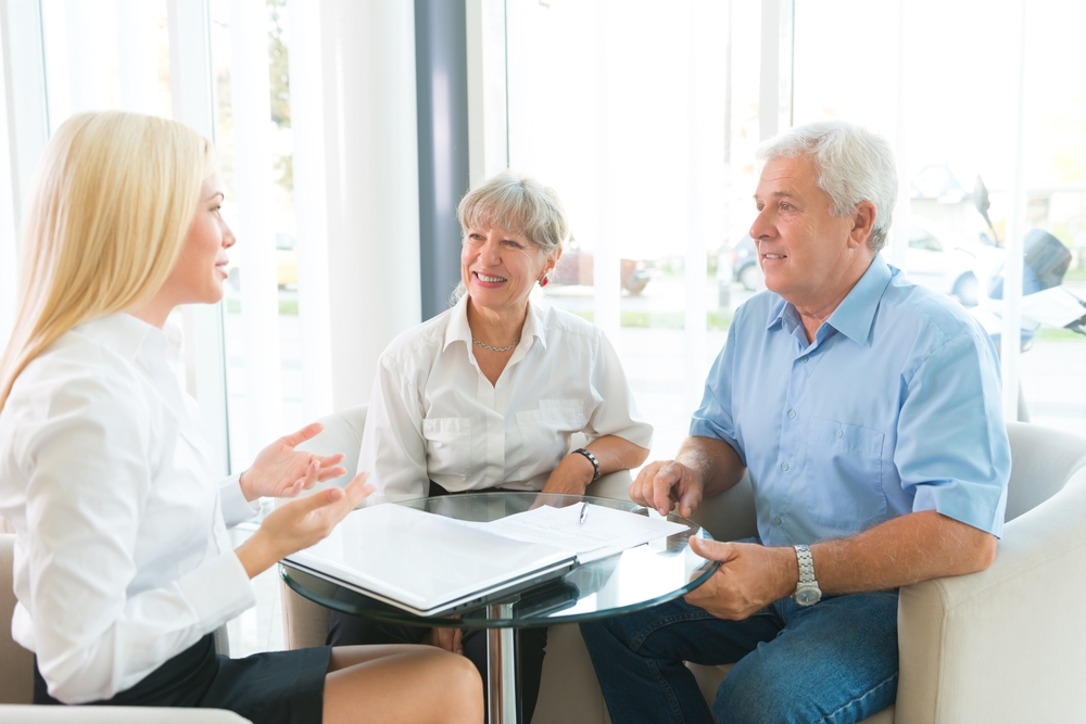 elderly couple purchasing life insurance with agent