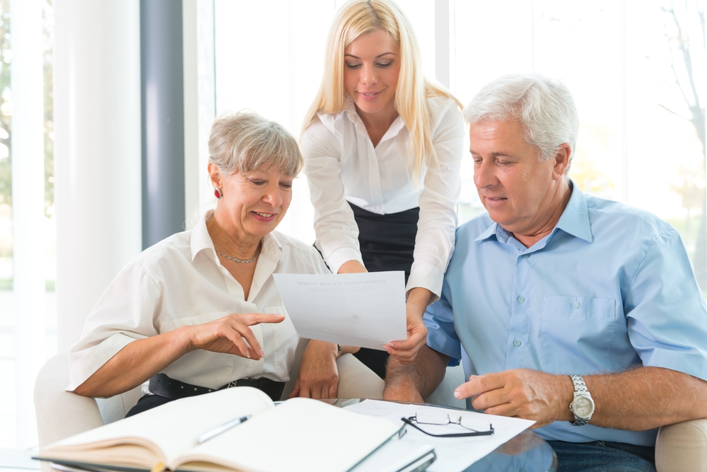 elderly couple talking to insurance agent about life insurance