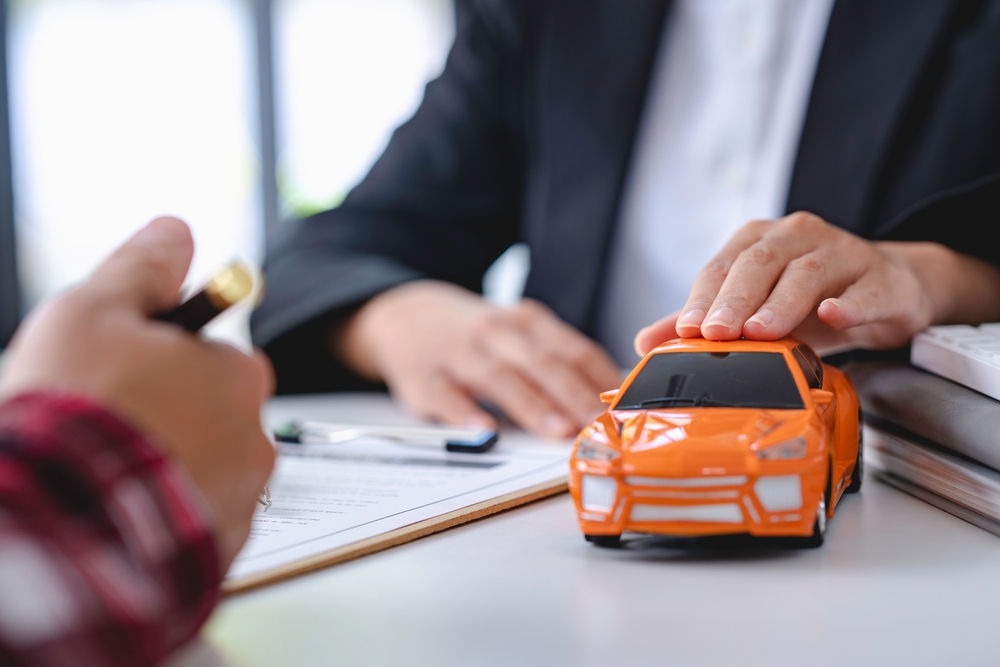 insurance agent sitting with client and paperwork