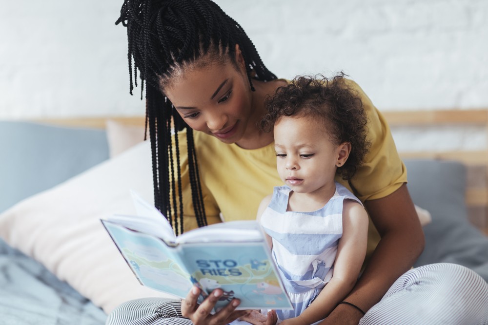 woman reading to toddler