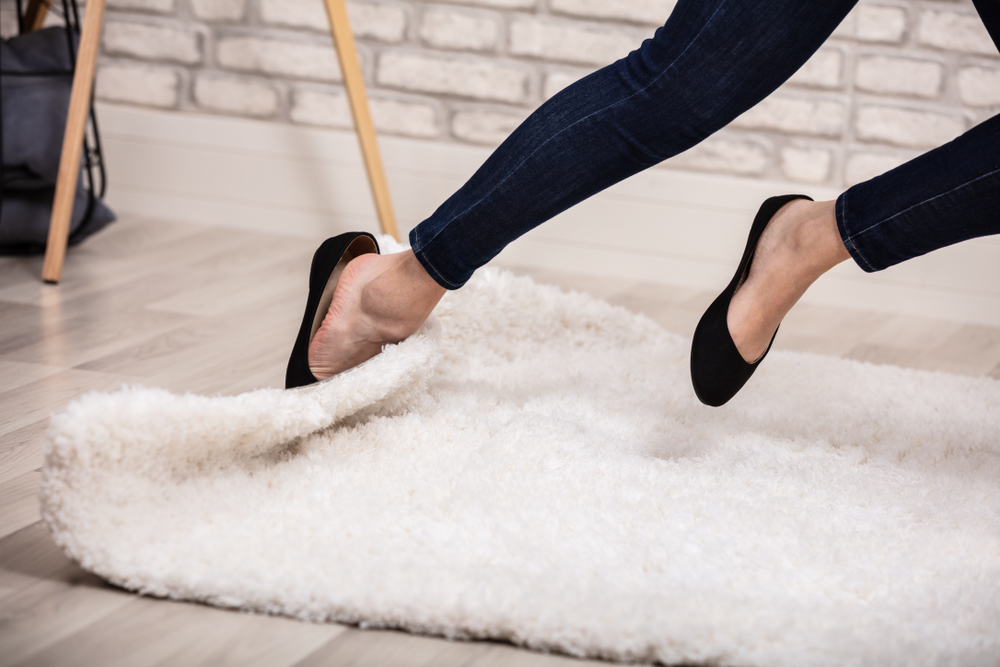 woman tripping on rug in house