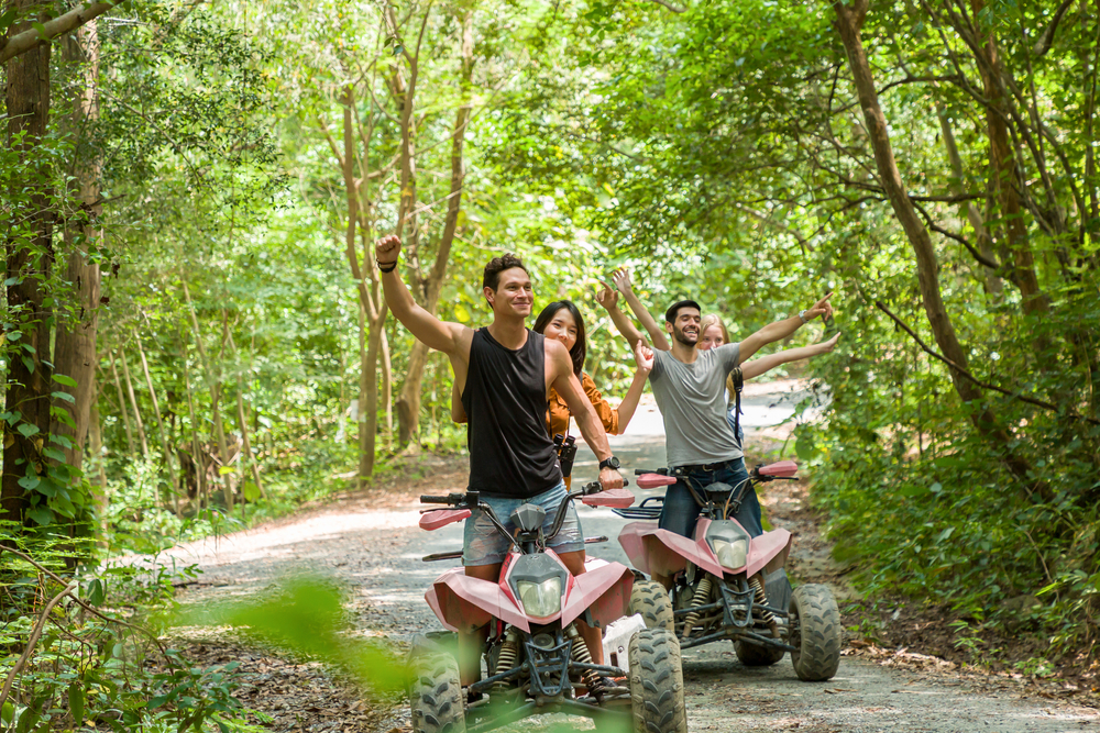 group of friends in forest on ATVs