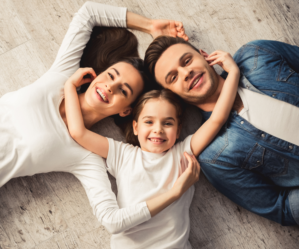 family of three smiling together