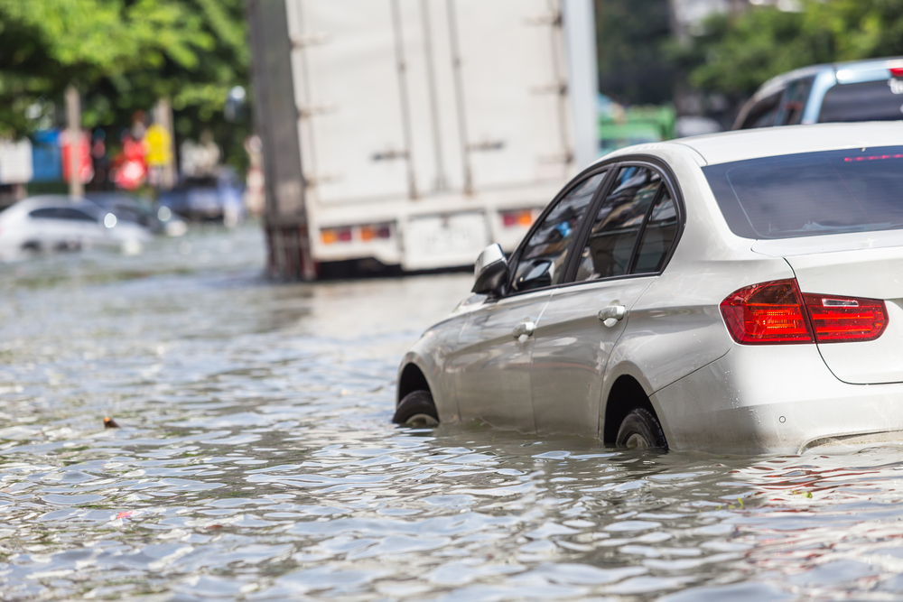 Cars navigate through flood waters