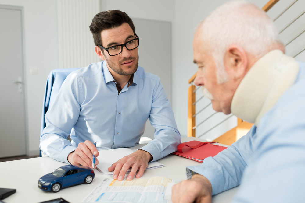 Attorney helps a man with a collar on his neck from an injury