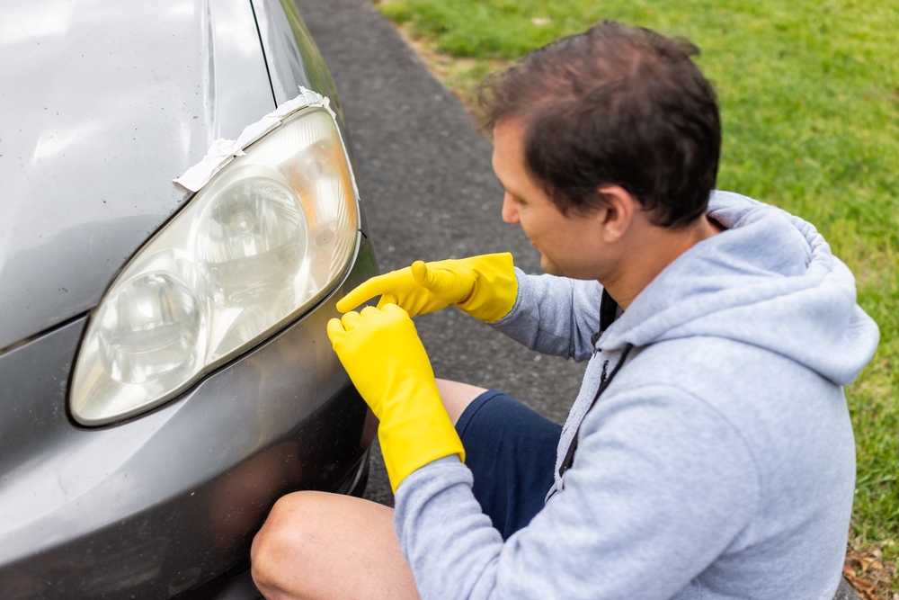 Man polishes headlights