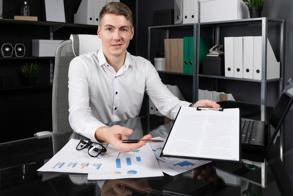 Young insurance agent considers paperwork