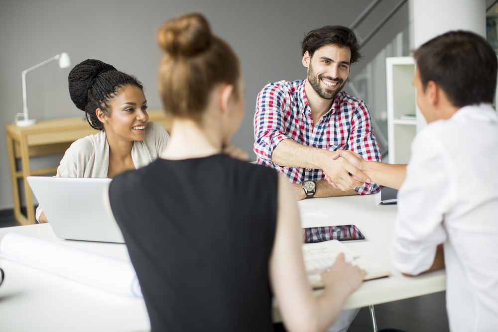 Young,People,In,The,Office New employee smiling shaking hands with boss