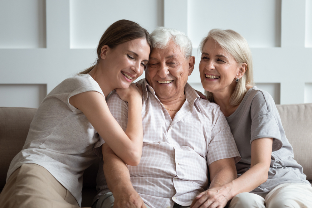 Three generations cuddle on the couch