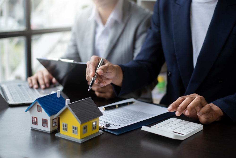 Landlord looking over landlord insurance contract with pen in hand