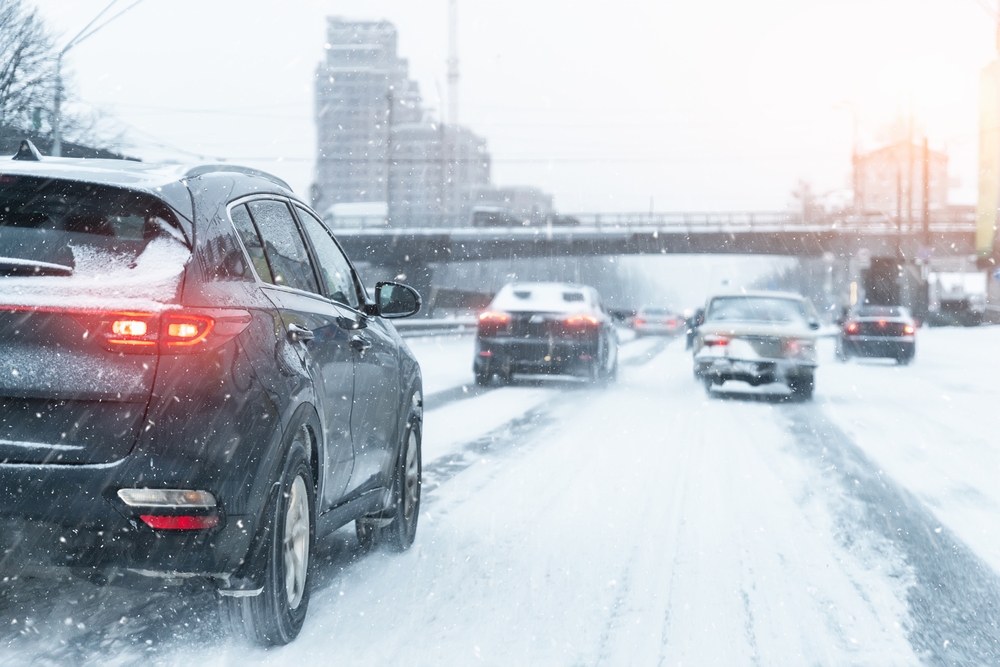 Cars driving through the blowing snow - car insurance