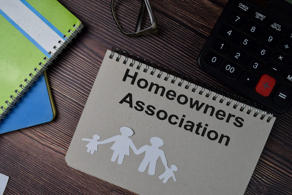 Homeowners association booklet on desk.