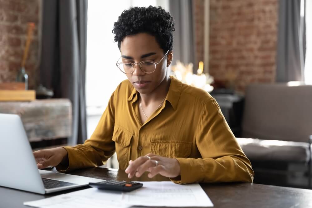 Young African American renters calculates how much renters insurance they need.