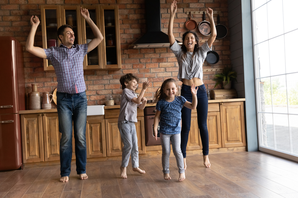 Happy couple celebrating because they just bought their home from a rent to own a home deal. Good thing they had proper renters insurance.