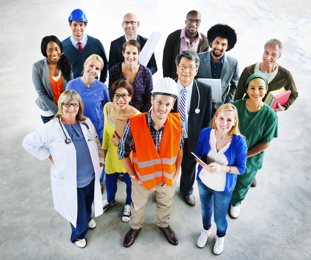 A group of different people with different jobs look up at camera - best car insurance.