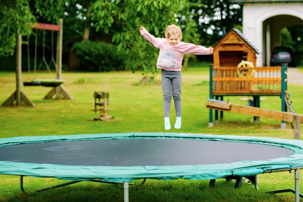 A toddler jumps on a trampoline - best homeowners insurance.